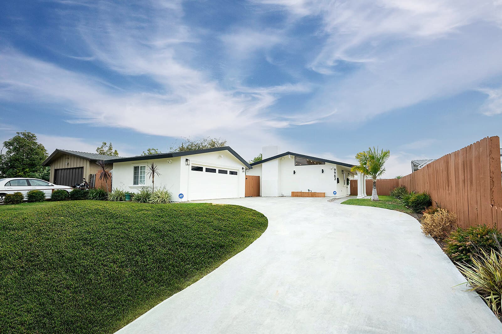 White ranch-style home with a long driveway at the Anaheim Disneyland Retreat