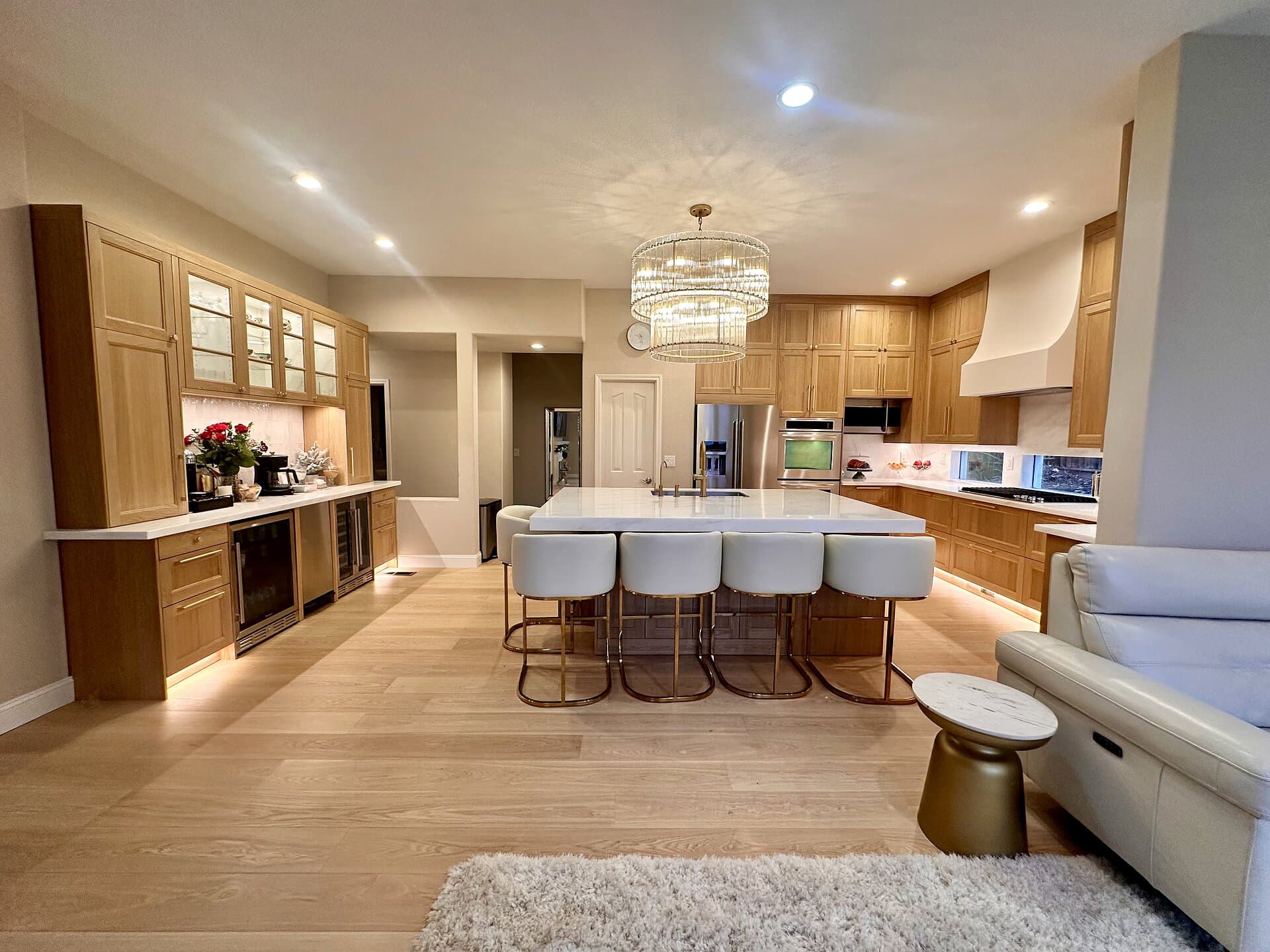 Remodeled kitchen with white oak cabinetry and stone island by I&H Builders